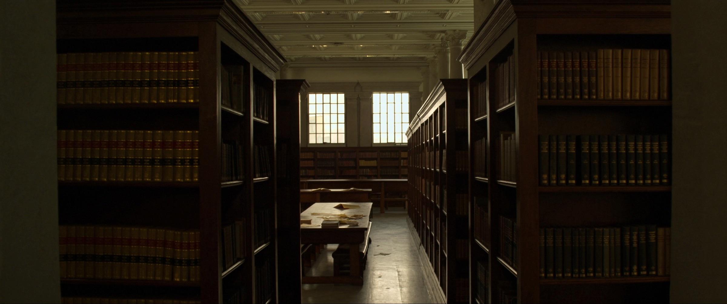 A law library reading room: shelves of bound volumes, a work table, tall windows.